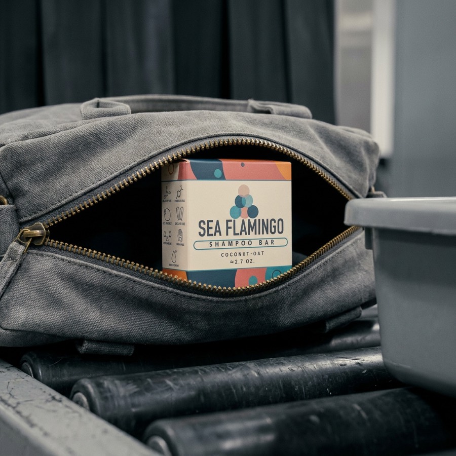 Sea Flamingo shampoo bar boxed in a travel bag on an airport conveyor